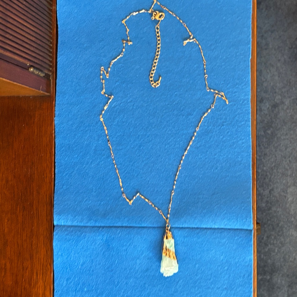 Elegant Necklace with Green stone overlaid with gold.